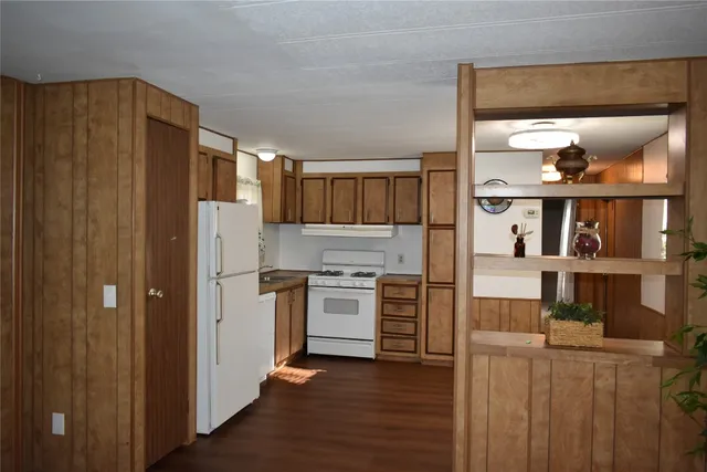 a kitchen with stainless steel appliances a refrigerator and a stove top oven