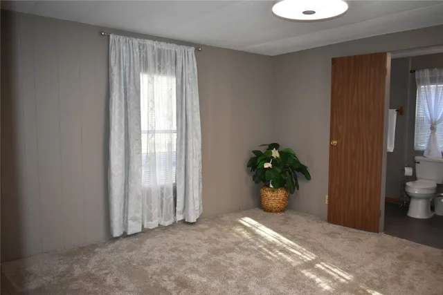 a view of an empty room and a window