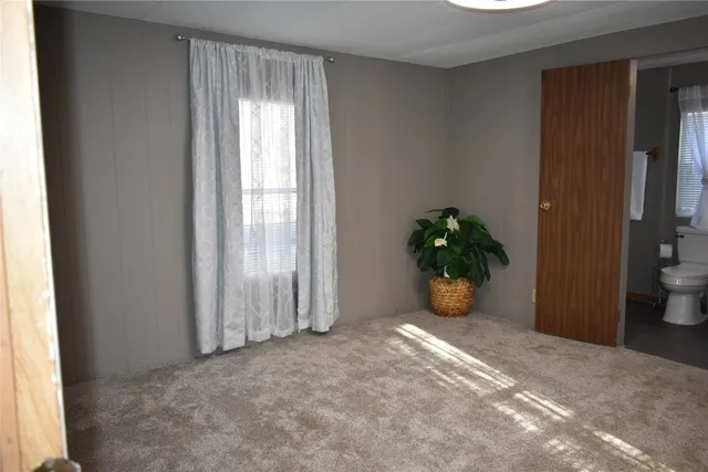 a view of a room with window and front door