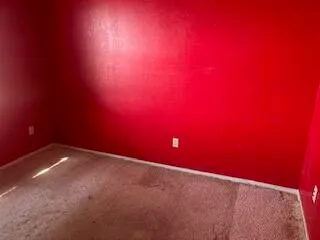 a bathroom with a granite countertop a sink and a window