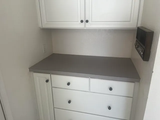 a view of a kitchen with an empty space and a sink