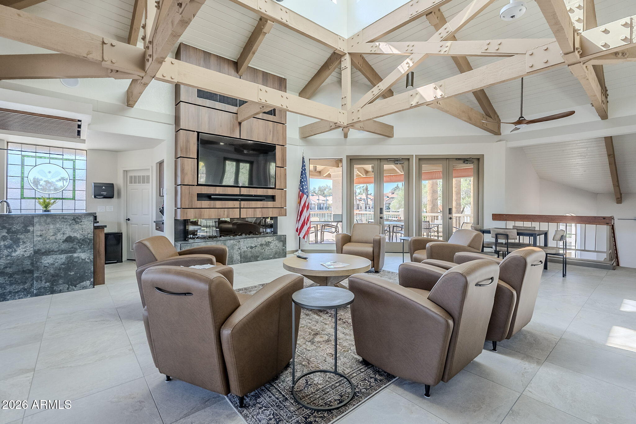 9711 East Mountain View Road, Unit 1502 Scottsdale, AZ 85258 - Photo 41 of 43 a living room with furniture a fireplace and a large window