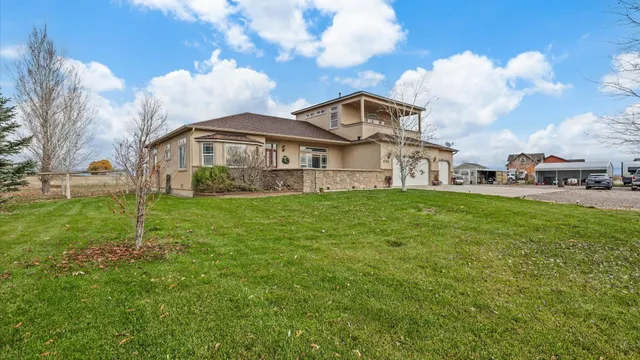 a view of a white house with a yard