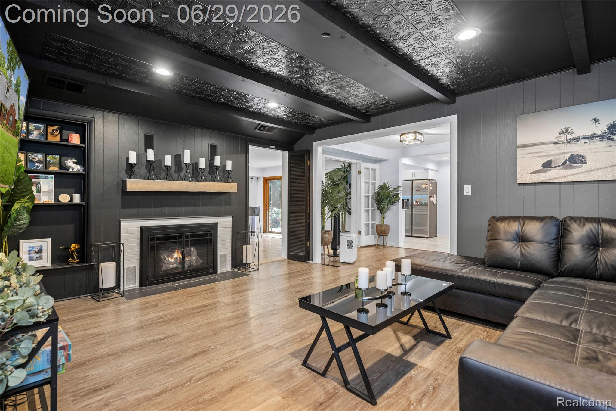 6085 Worlington Road Bloomfield Hills, MI 48301 - Photo 26 of 75 2nd Living area featuring wood-finish flooring, a fireplace with a white tile surround and wood mantel, recessed lighting, and a decorative ceiling with exposed beams