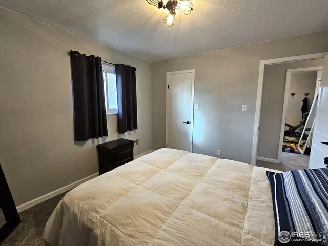 a bedroom with a bed and a large mirror