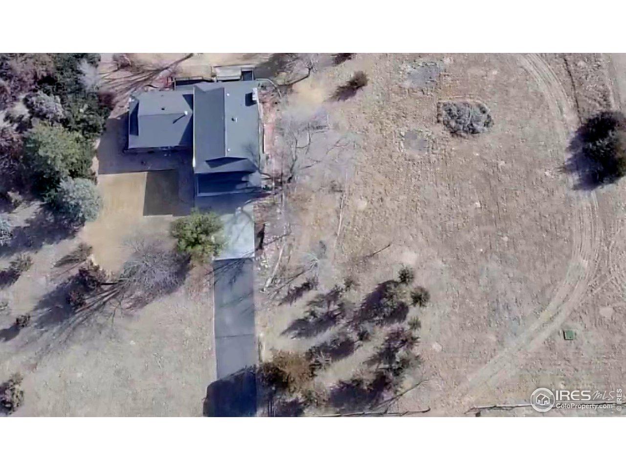 511 Pawnee Drive Sterling, CO 80751 - Photo 3 of 50 Aerial view of home, paved drive and extra lot taken from the west side of the property