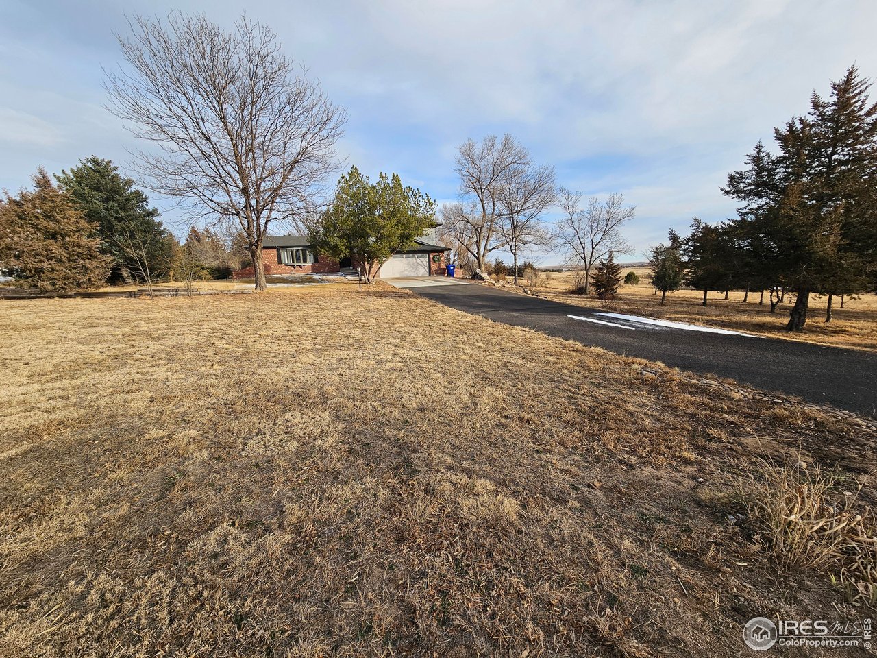 511 Pawnee Drive Sterling, CO 80751 - Photo 47 of 50 Paved drive leads to the driveway approach to the garage
