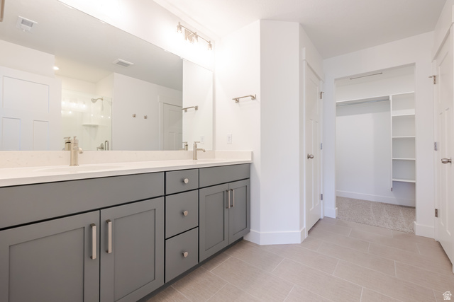 5228 South Acacia Drive, Unit 808 Mapleton, UT 84664 - Photo 15 of 22 Dual vanity with gray cabinetry, white countertops, and brushed nickel fixtures