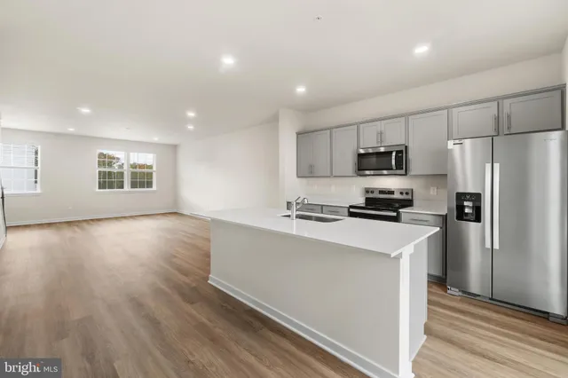 a kitchen with stainless steel appliances a refrigerator stove microwave and sink