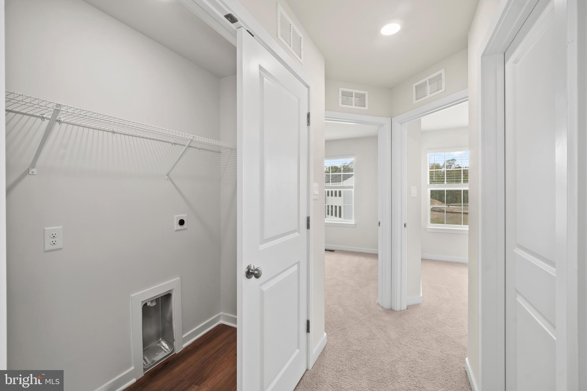 238 Soft Rush Lane La Plata, MD 20646 - Photo 17 of 33 a view of a hallway with wooden floor and closet