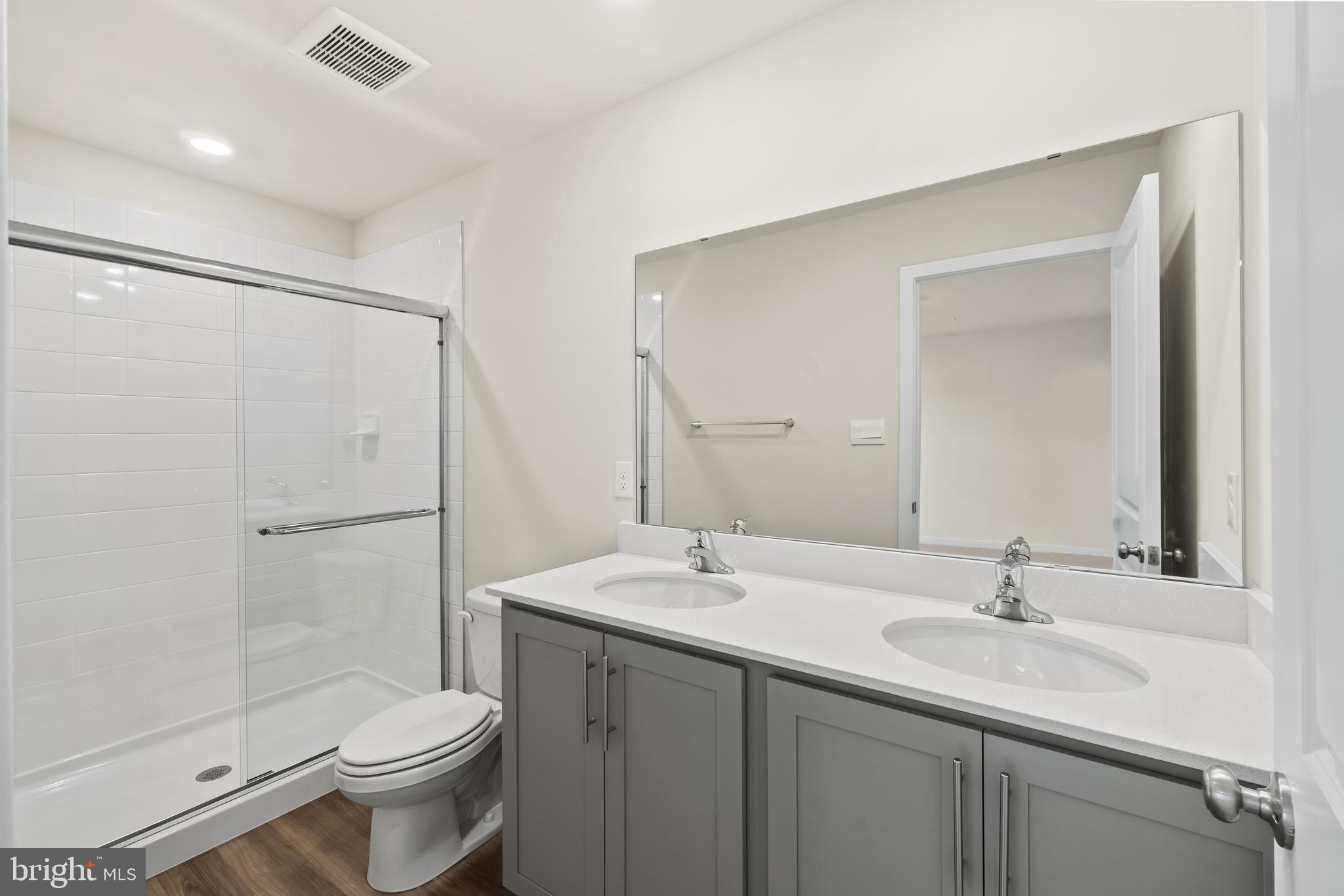 238 Soft Rush Lane La Plata, MD 20646 - Photo 27 of 33 a bathroom with a sink toilet a mirror and shower