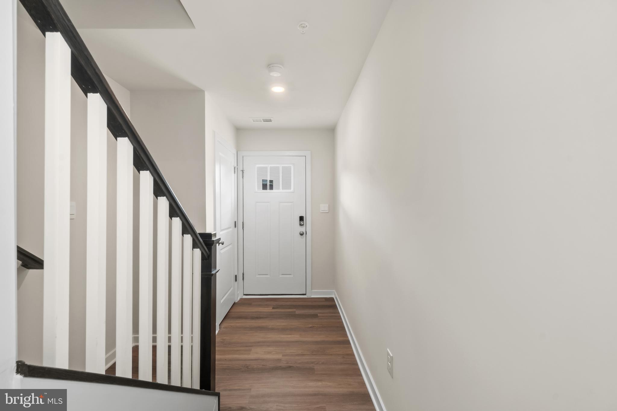 238 Soft Rush Lane La Plata, MD 20646 - Photo 3 of 33 a view of a hallway with wooden floor and staircase