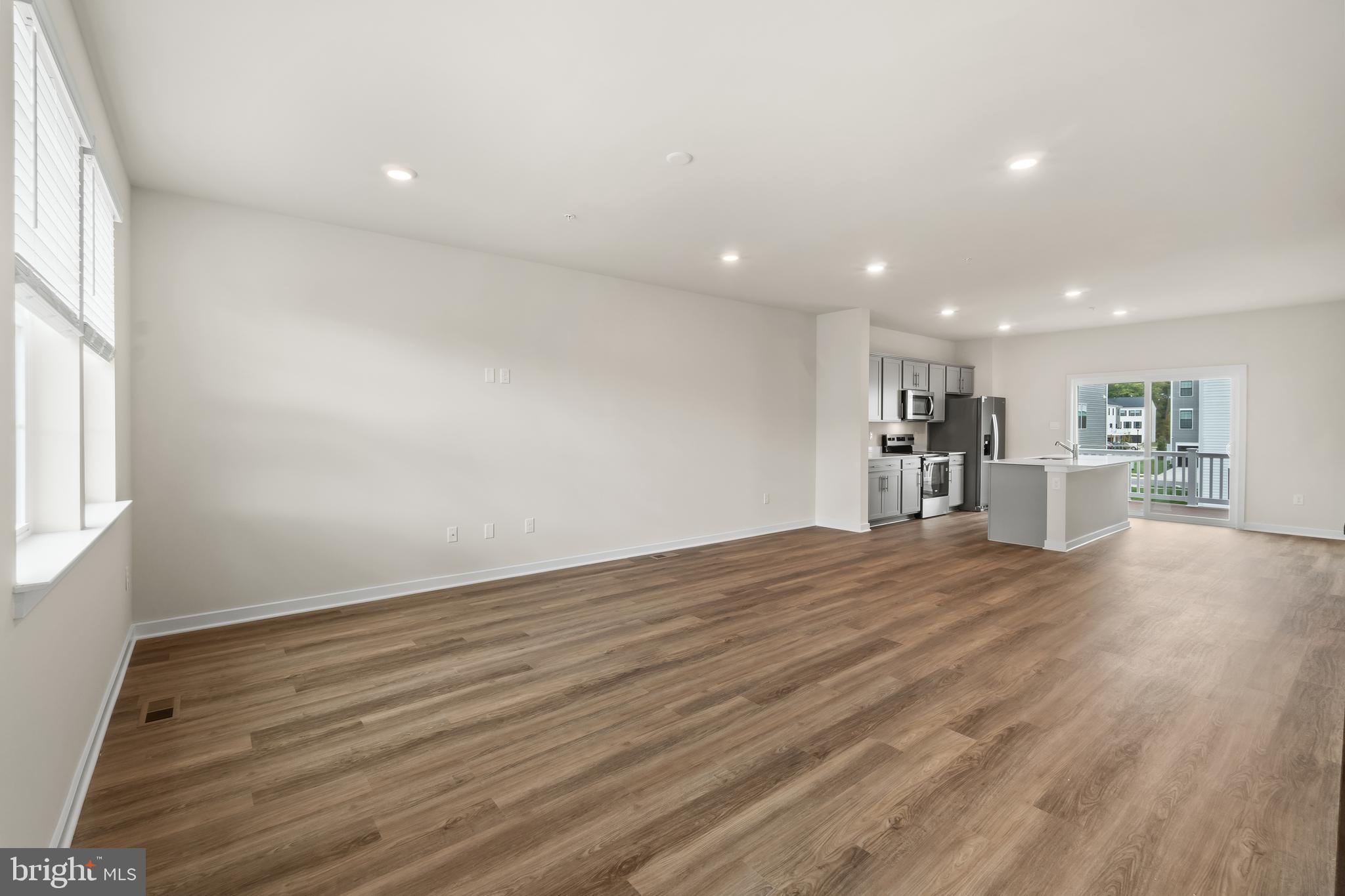 238 Soft Rush Lane La Plata, MD 20646 - Photo 9 of 33 an empty room with wooden floor and windows