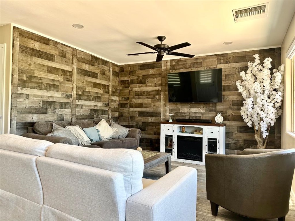 1395 Lause Road Bullhead City, AZ 86442 - Photo 6 of 34 Interior living area with wood-finish accent walls, recessed lighting, and a ceiling fan