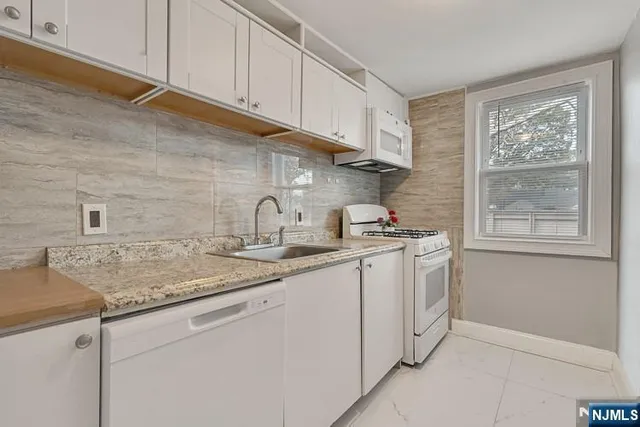 a kitchen with sink cabinets and window