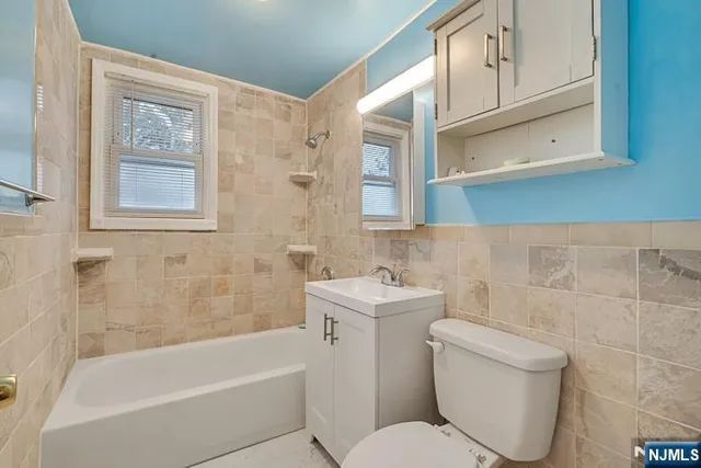 a bathroom with a toilet a sink and bathtub