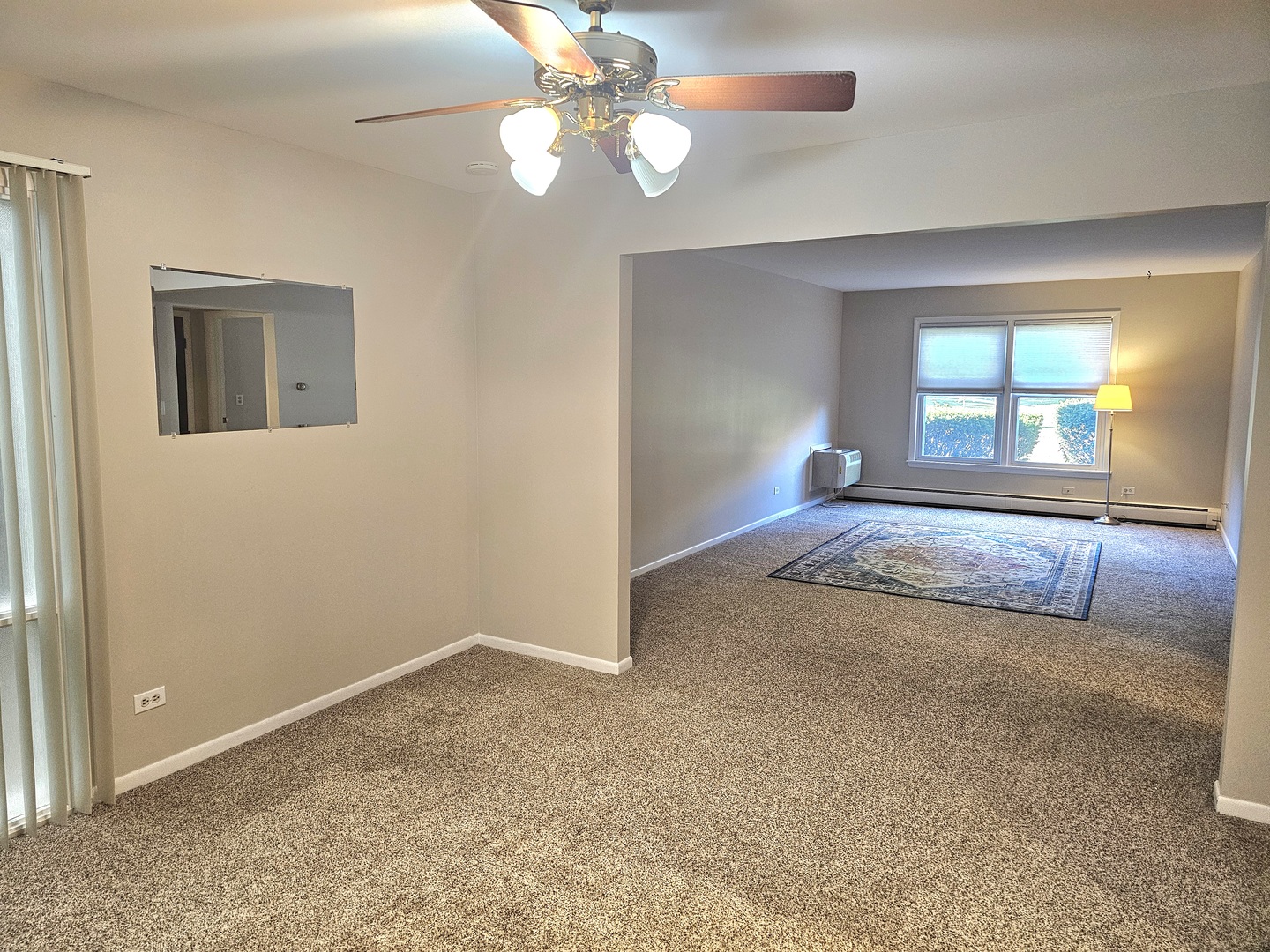 350 Brainerd Avenue, Unit 7A Libertyville, IL 60048 - Photo 2 of 9 an empty room with windows and fan