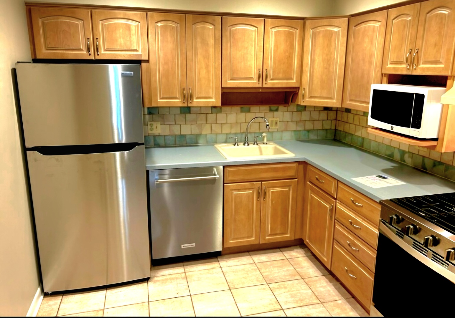 350 Brainerd Avenue, Unit 7A Libertyville, IL 60048 - Photo 8 of 9 a kitchen with stainless steel appliances a refrigerator sink and microwave