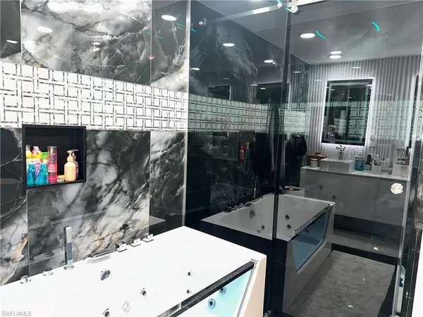 a bathroom with a sink a mirror and shower