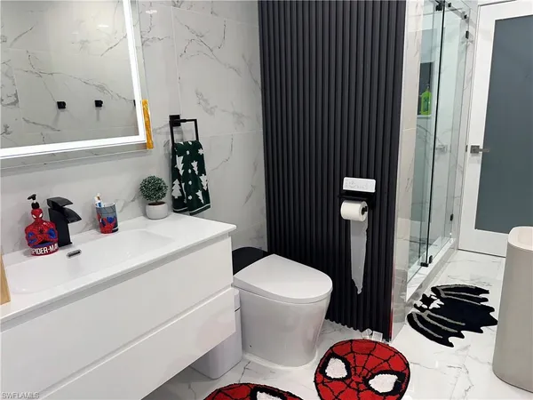 a bathroom with a sink toilet and shower