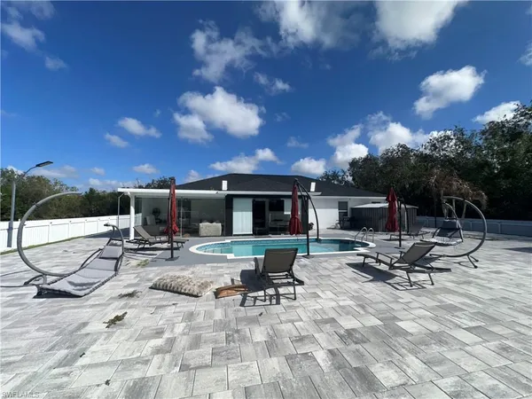 a view of a backyard with sitting area