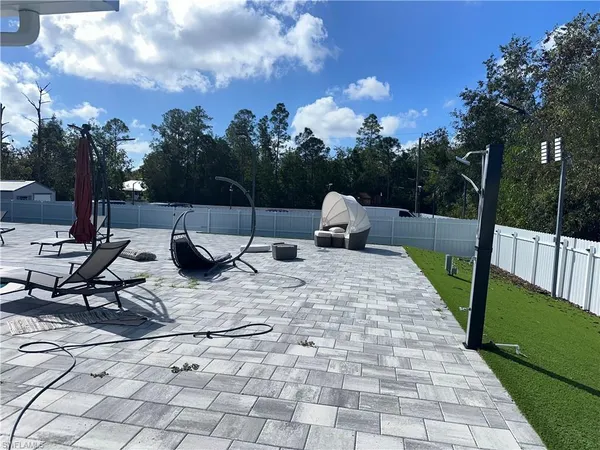 a view of swimming pool with sitting area