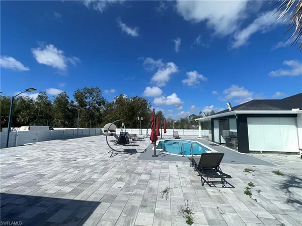 a view of a swimming pool with a patio