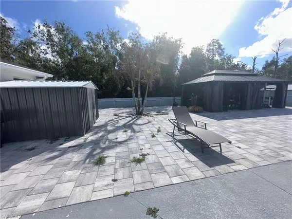 a view of a backyard with a patio