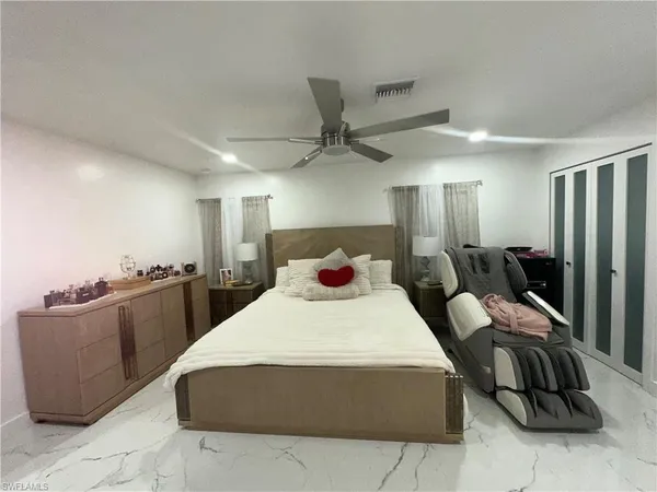 a bedroom with a bed and a chandelier