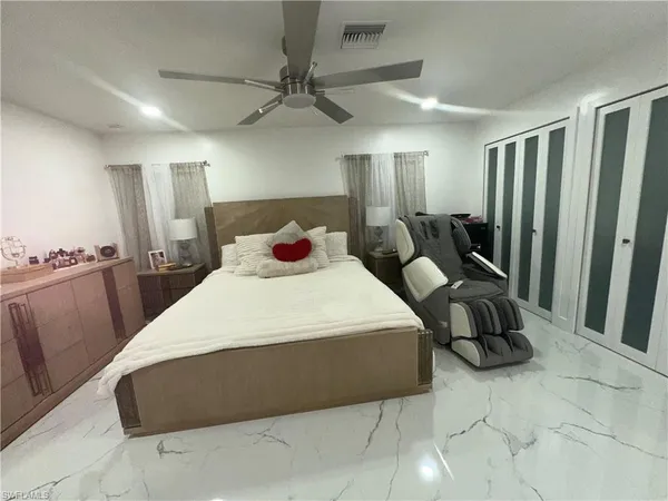 a bedroom with a bed and a chandelier