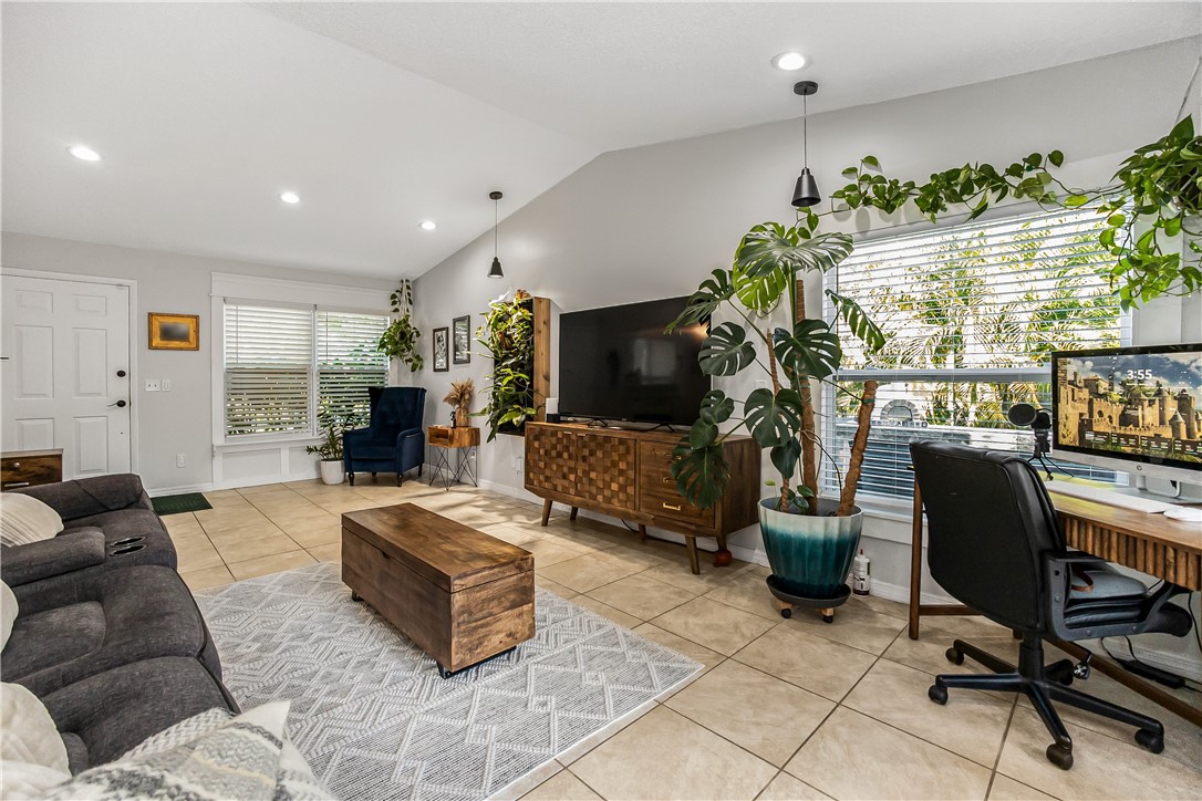 762 Bayharbor Terrace Sebastian, FL 32958 - Photo 17 of 24 a living room with furniture a flat screen tv and a large window
