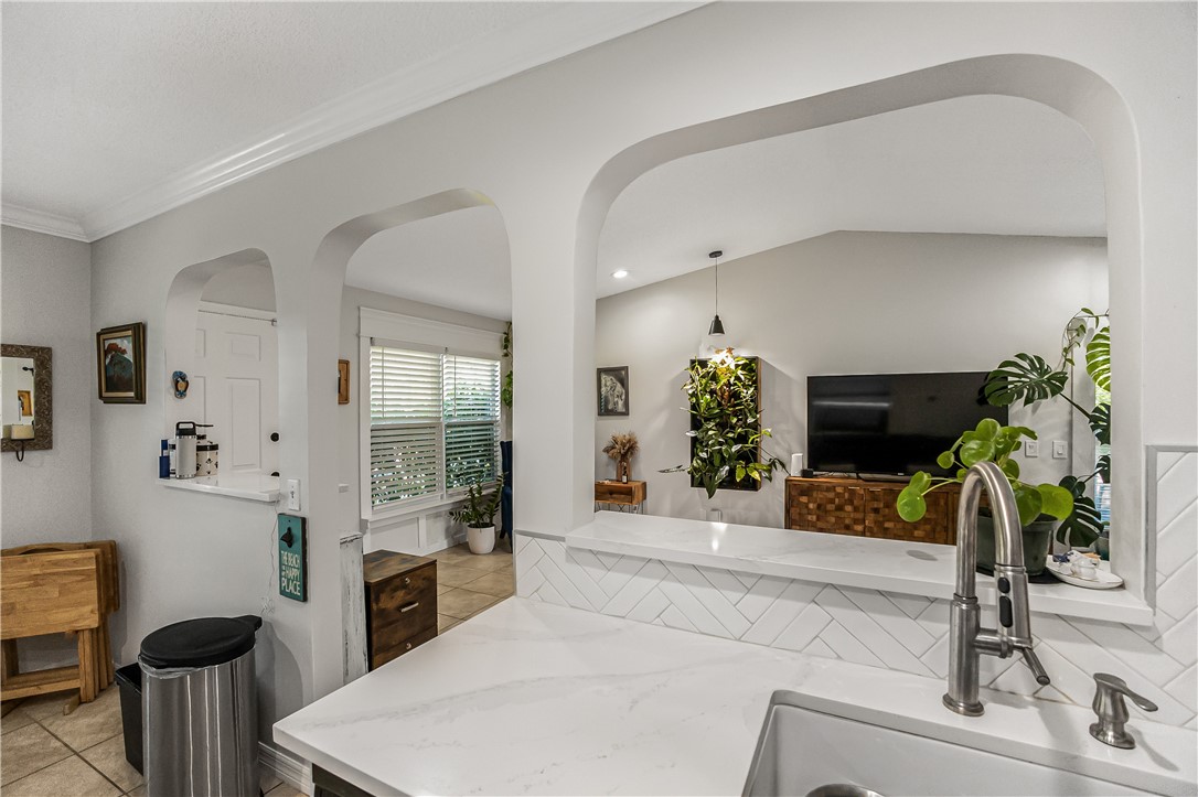 762 Bayharbor Terrace Sebastian, FL 32958 - Photo 19 of 24 a living room with furniture potted plant and a fireplace