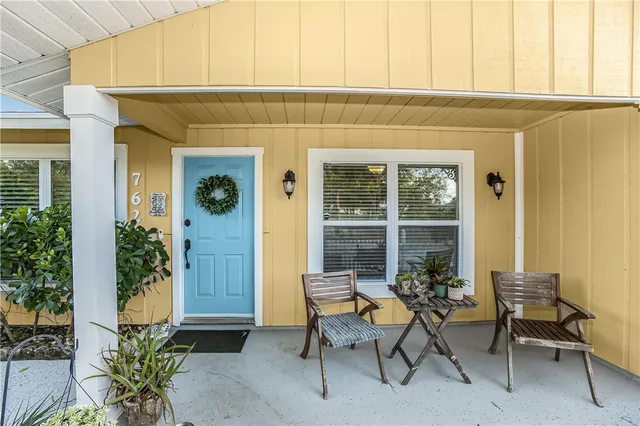 a backyard of a house with table and chairs