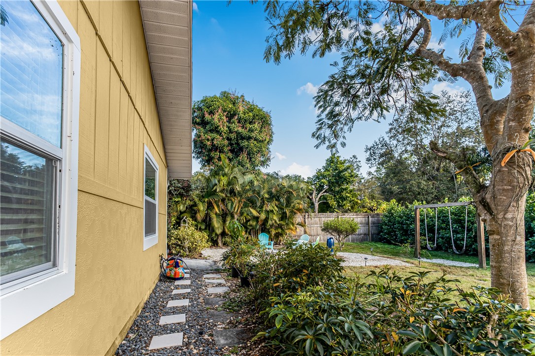 762 Bayharbor Terrace Sebastian, FL 32958 - Photo 5 of 24 a view of a yard with plants and wooden fence