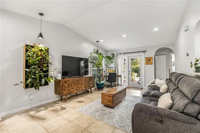 a living room with furniture and a potted plant