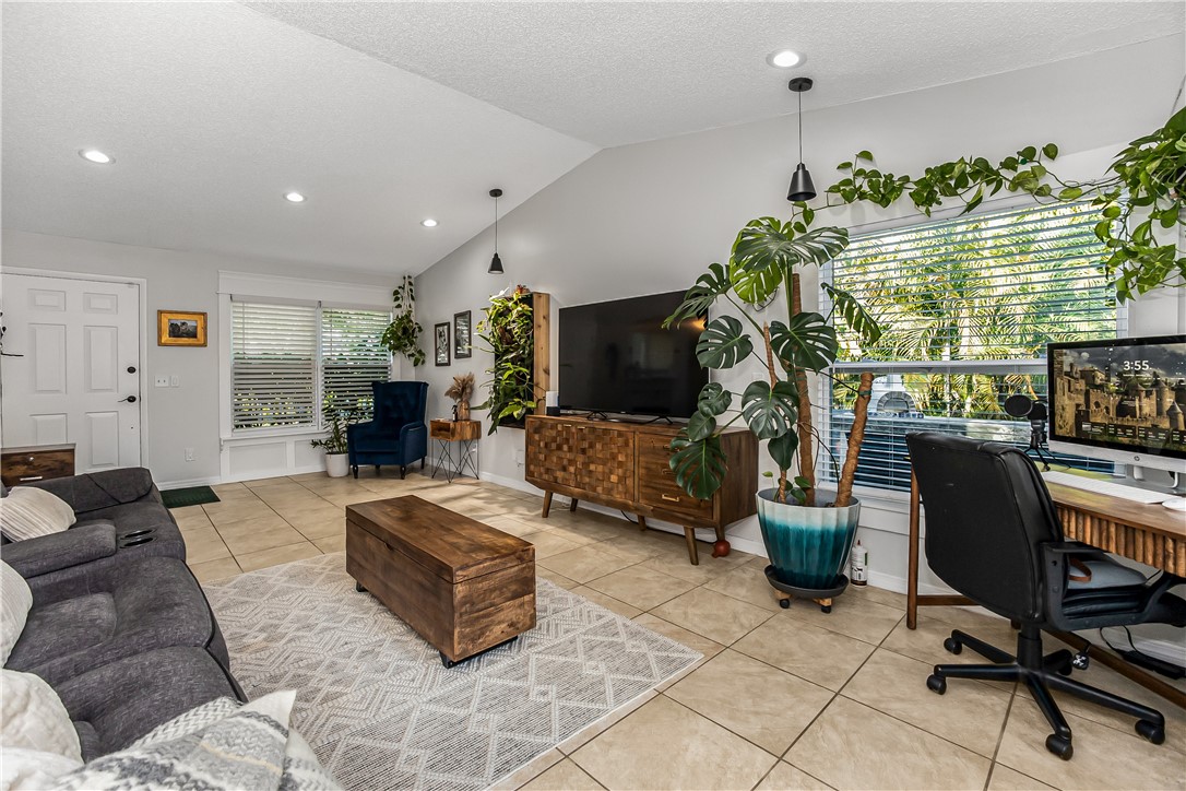 762 Bayharbor Terrace Sebastian, FL 32958 - Photo 10 of 24 a living room with furniture plant and a large window