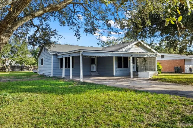 a view of a house with a yard and sitting area