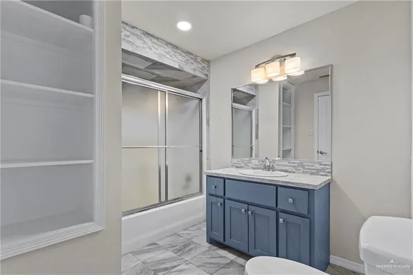 a bathroom with a double vanity sink and mirror