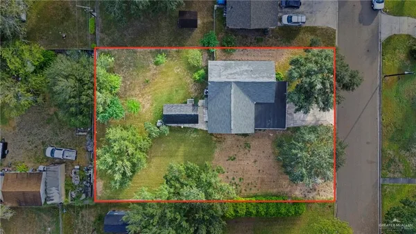 an aerial view of a house with a yard basket ball court and outdoor seating