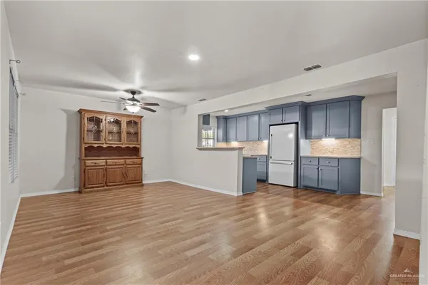 a view of a kitchen with a sink and a refrigerator