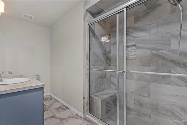 a bathroom with a shower and a sink