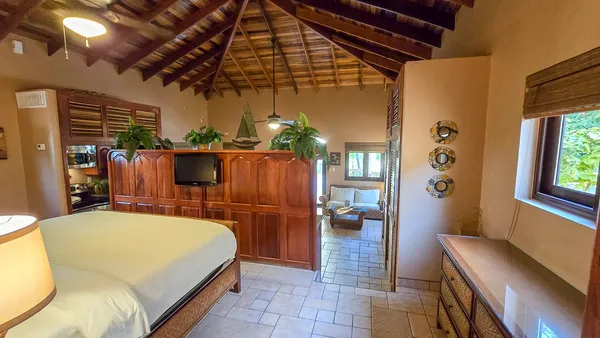 a bed room with a bed and a chandelier