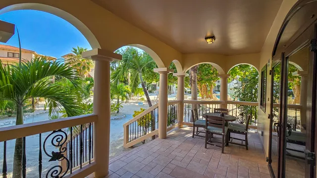 a view of a chairs and table in patio with potted plants