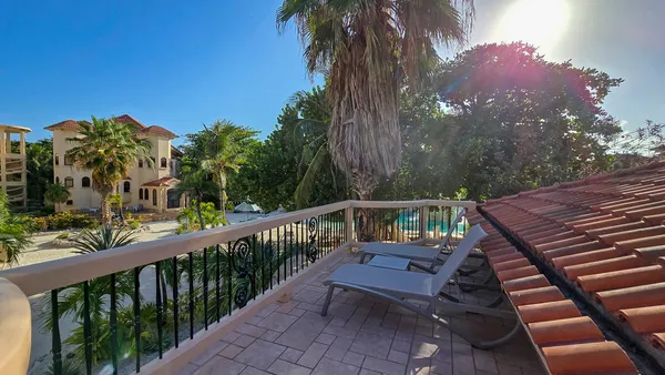 a view of a balcony with wooden floor and fence