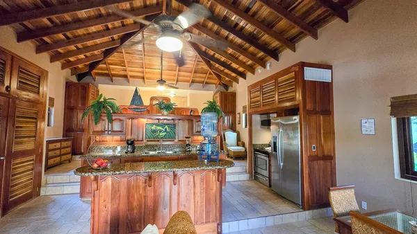 a view of kitchen with stainless steel appliances granite countertop lots of counter top space