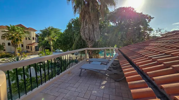 a view of a balcony with wooden floor and fence