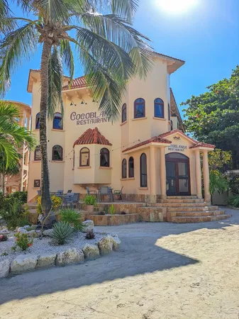 a view of a white house with a yard