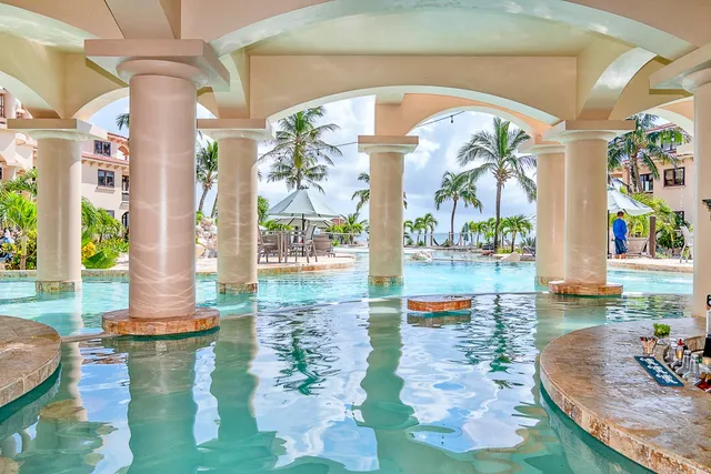 a swimming pool with outdoor seating