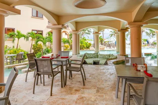 a view of a dining room with furniture a chandelier and wooden floor