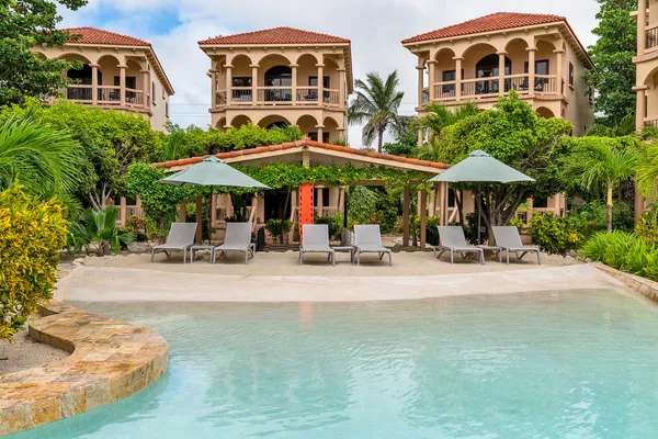 a couple of table and chairs under an umbrella